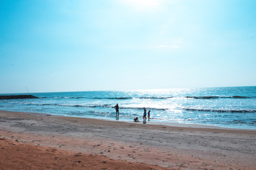 Fototapeta na wymiar family walk in the Beach and tropical sea in Sri lanka