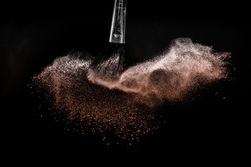 Fototapeta premium Living Coral Color of the year 2019, powder splash and brush for makeup artist or beauty blogger in black background