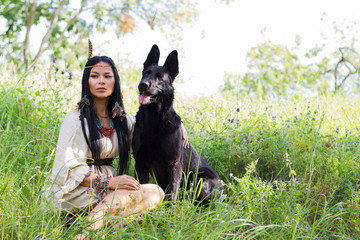 woman and dog posing in the forest