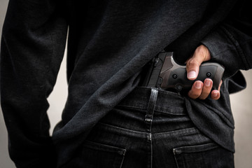 A man holding a gun in hand, the ship ready to shoot the man pointed a gun at us. A man holding a...