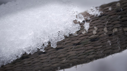 Ice on a brown rattan surface