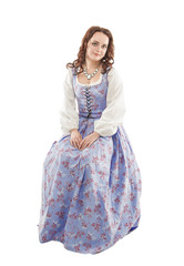 Young beautiful woman in long medieval dress sitting isolated