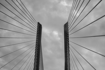 Black and white low-angle view of Vasco da Gama Bridge in Portugal