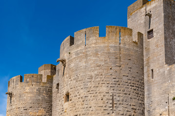Fototapeta na wymiar Aigues-Mortes in the south of France, the walls of the city with the gargoyles 