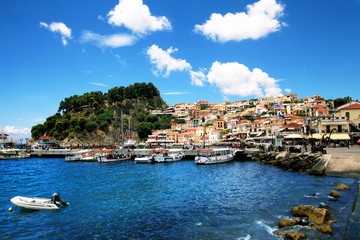 Fototapeta na wymiar Wonderful view of colorful houses, boats and fortress in Parga, Greece