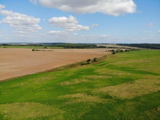 Fototapeta premium Top view of the fields and harvest. Shooting from the quadcopter. sunny day