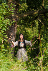 woman shaman conjures in the forest