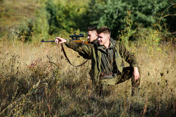 Hobby for real men concept. Hunters with rifles in nature environment. Hunter friend enjoy leisure...