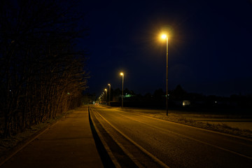 Road lights in night, street post shadow