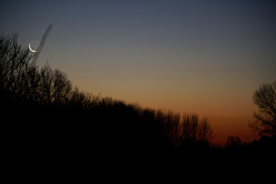 Sunrise in field with a cloudy sky