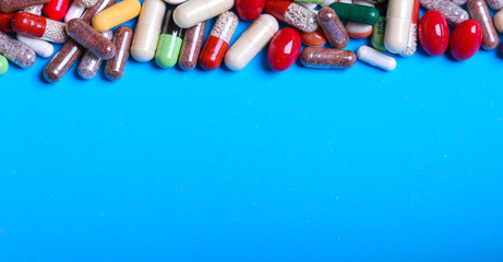 Medical pills on blue background