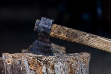 Cut logs fire wood and old axe. Old axe stuck in log.  Renewable resource of a energy. Environmental concept