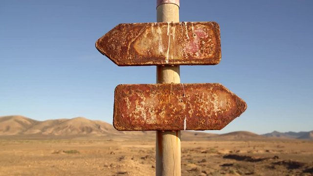 Old rotten sign in a desert. Fuerteventura, Spain