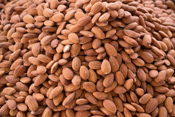 Pile of peeled almonds close-up as background
