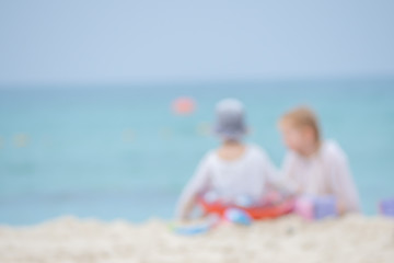 De focus or blurred Children playing on the beach with happiness near the parent. Children building something on the beach. Background concept - Image