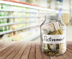 Coins in glass money jar on  background