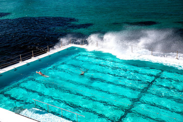 Beautiful pool along the ocean with swimmers