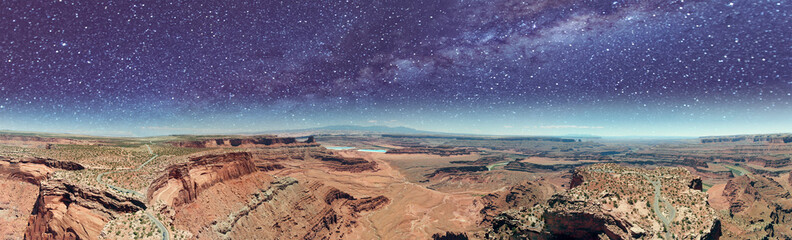 Aerial panorama of Dead Horse in Canyonlands at night with stars