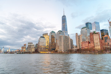 Fototapeta na wymiar Sunset Manhattan skyline from a cruise ship, New York City