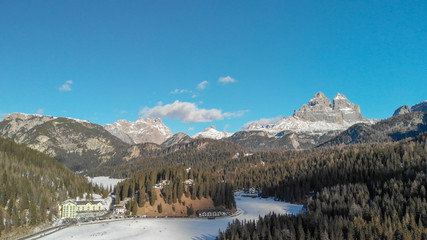 Mountains and iced lake of Misurina, aerial view of italian alps