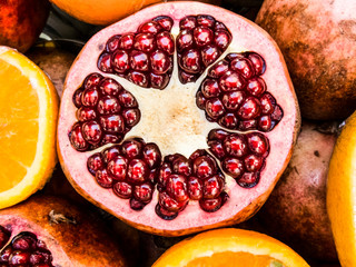 red close up of a pomegranate - season fresh healthy fruit for correct food alimentation like...
