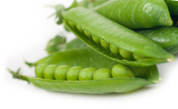 green peas in pods on a white background