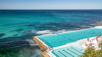 BONDI BEACH, AUSTRALIA - AUGUST 18, 2018: Tourists and locals enjoy Iceberg Pools. The pools are a famous attraction among tourists