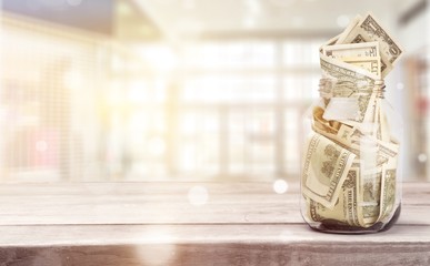 Glass jar for money  on background