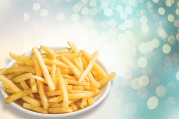 Plate of french fries on wooden table