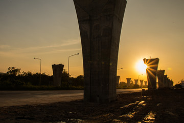 Construction crane and girder of bridge construction site and sunset.New expressway construction...
