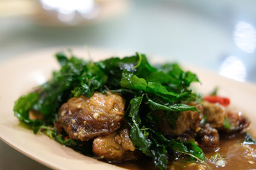 Stir-fried basil leave with fried preserved egg.