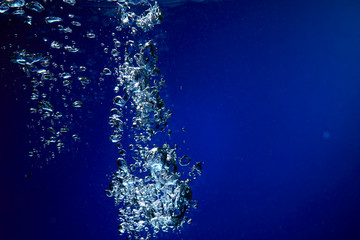 Ice cubes falling into the water