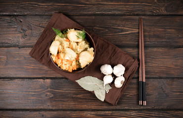 Obraz na płótnie Canvas Bowl with boiled rice and meat and Chinese chopsticks