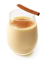 Eggnog with cinnamon stick isolated on white background