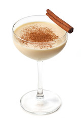 Eggnog with cinnamon stick isolated on white background