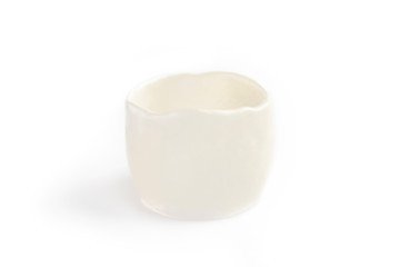 translucent image of clay cup, made by hand from white clay. Double burning. Transparent glaze applied by hand. Handmade, single copy. White background, isolated