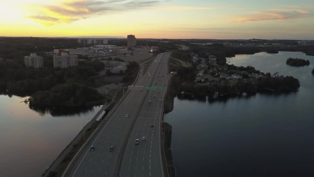 Aerial panoramic view of a Highway in the Modern City during a vibrant Sunset. Taken in Halifax, Dartmouth, Nova Scotia, Canada.