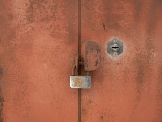 old rusty lock on metallic doors