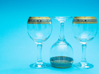 three empty wine glasses on blue background