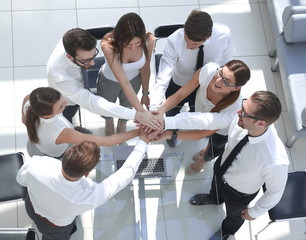 top view.employees of the company making a tower out of hands