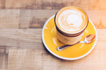 Latte art coffee on wood table background. Top view.