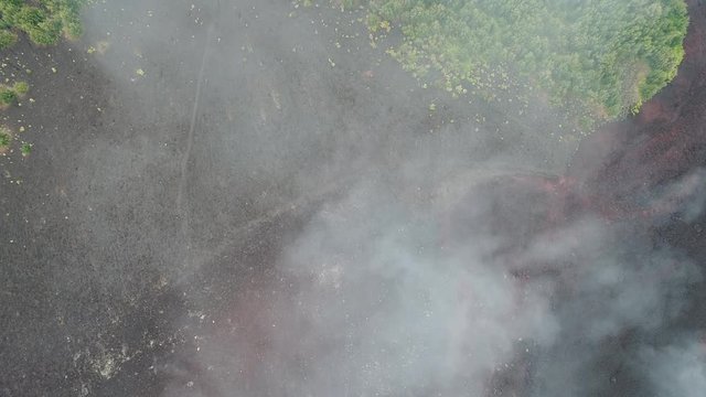 Aerial Footage of Krakatoa coastline (Anak Krakatau) taken Oct 2017 looking down through clouds -Raw Footage