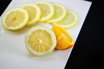 fresh cut slices of lemon and orange on  white background