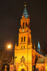 neo-Gothic brick Catholic church at night in Poznan.
