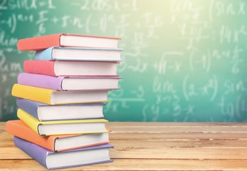 Stack books on wooden desk table