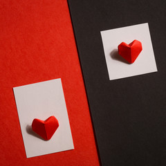 two large paper hearts on red-black background. contrast, minimalism. concept: Valentine's day, love, barrier