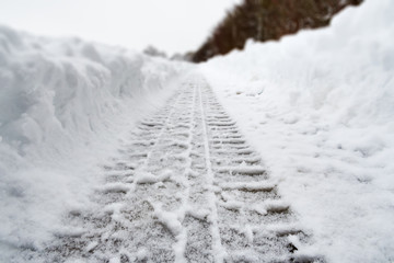 Image of car tracks in white snow
