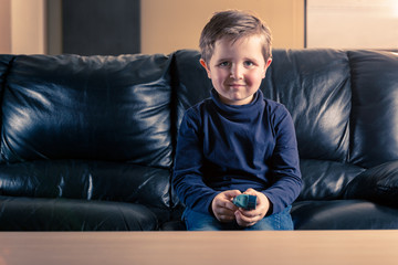 little boy in sofa and with asthma inhaler