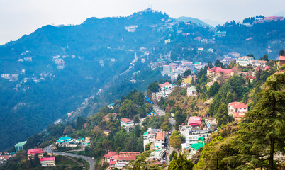 Fototapeta na wymiar An Aerial landscape view of Mussoorie or Mussouri hill top peak city located in Uttarakhand India with colorful buildings