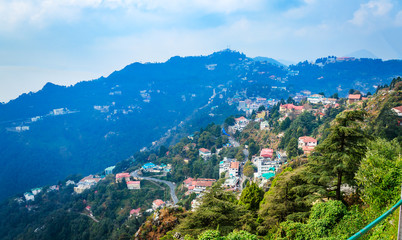 An Aerial landscape view of Mussoorie or Mussouri hill top peak city located in Uttarakhand India with colorful buildings